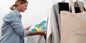 Young woman inspecting custom clothing